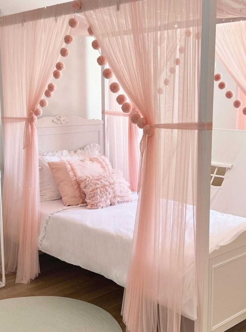 white bed frame with white and pink linens and a pink canopy