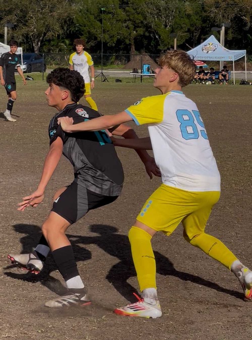 teens playing soccer