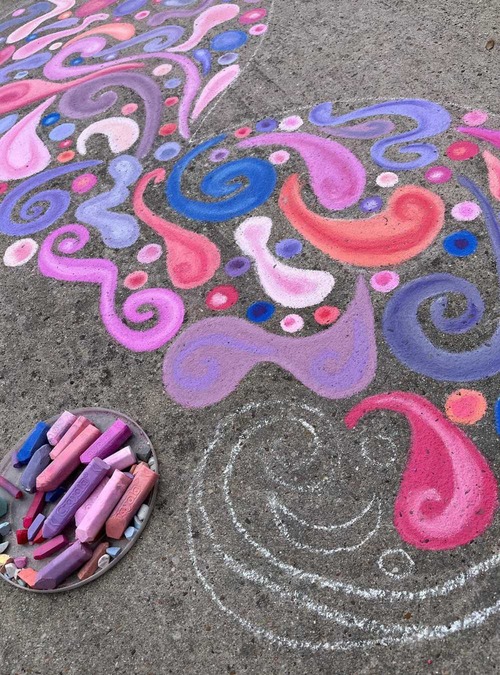 pink, purple, and blue chalk art on a sidewalk