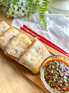 rice paper dumplings with a bowl of dipping sauce