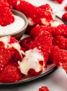 plate of hot cheeto cheese sticks with dipping sauce