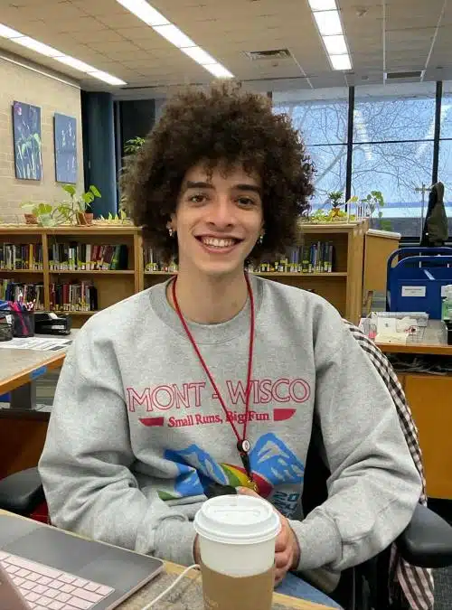 smiling teen sitting in a library