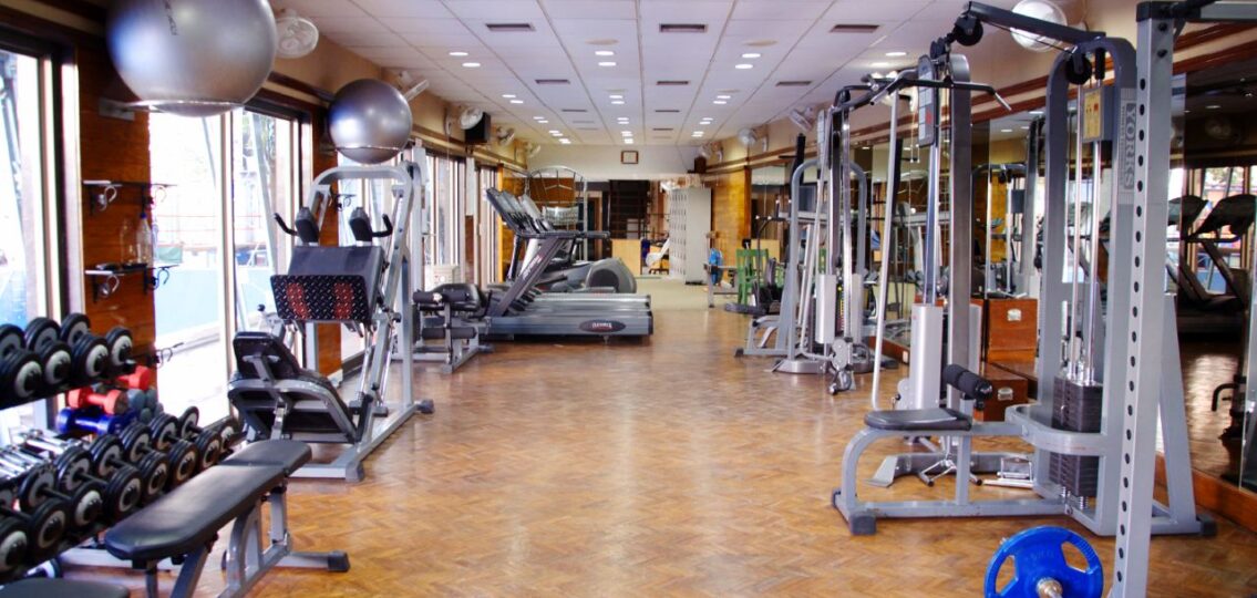 inside of a gym with workout equipment and weights