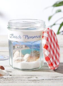 empty jam jar decorated with a photo of a beach scene with the text "Beach Memories"