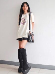 woman wearing an oversize t-shirt with black shorts and black boots