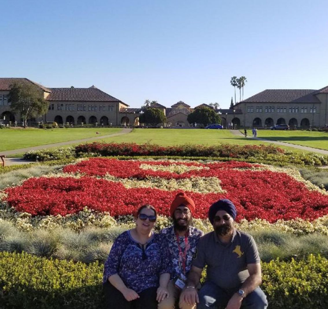 the author and his parents sitting in front of a Stanford flower garden